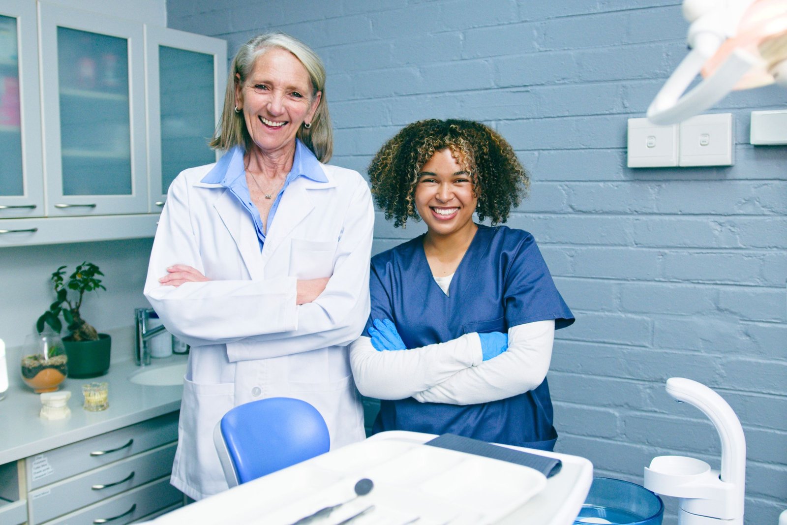 Dental professionals standing together inside a modern dental practice treatment room