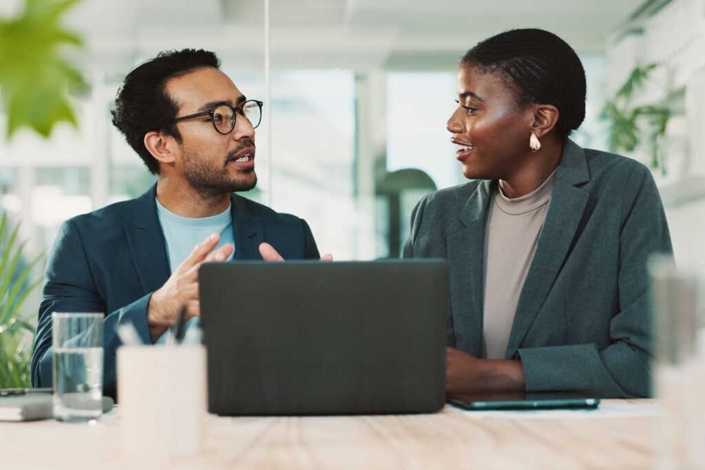 Business buyers and sellers discussing deal terms and earn-out structure during an acquisition negotiation