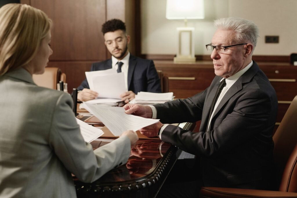 Attorney reviewing legal documents with clients during a law firm consultation meeting