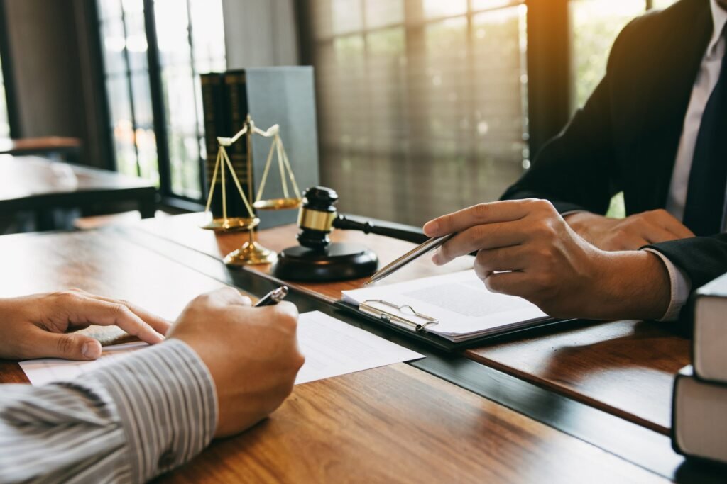 Attorney discussing legal paperwork across a desk in a professional law office