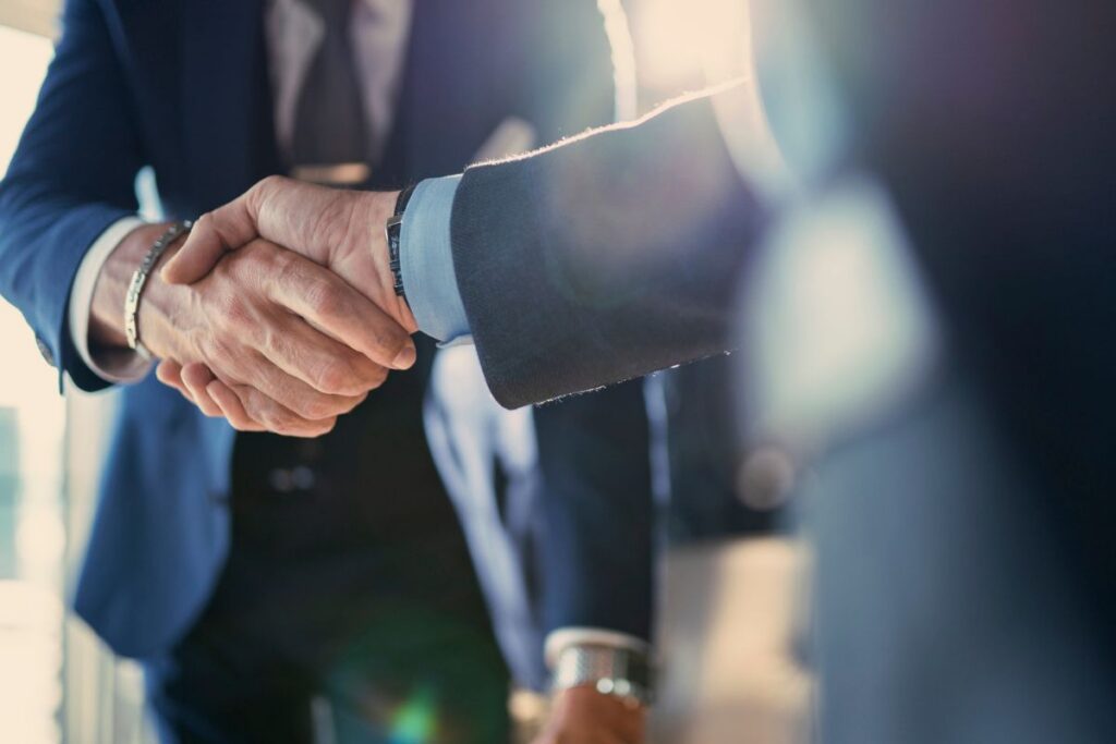 Business professionals shaking hands during a meeting