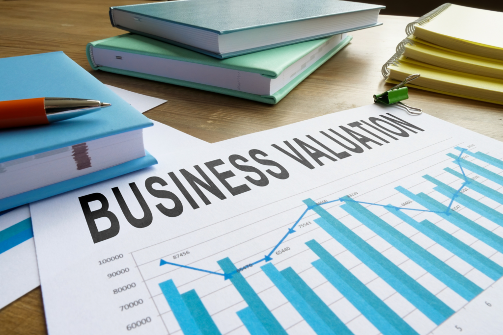 Business valuation report with financial documents and legal books on a desk
