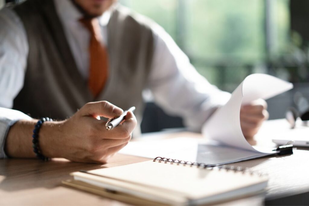 Business professional reviewing financial documents at a meeting