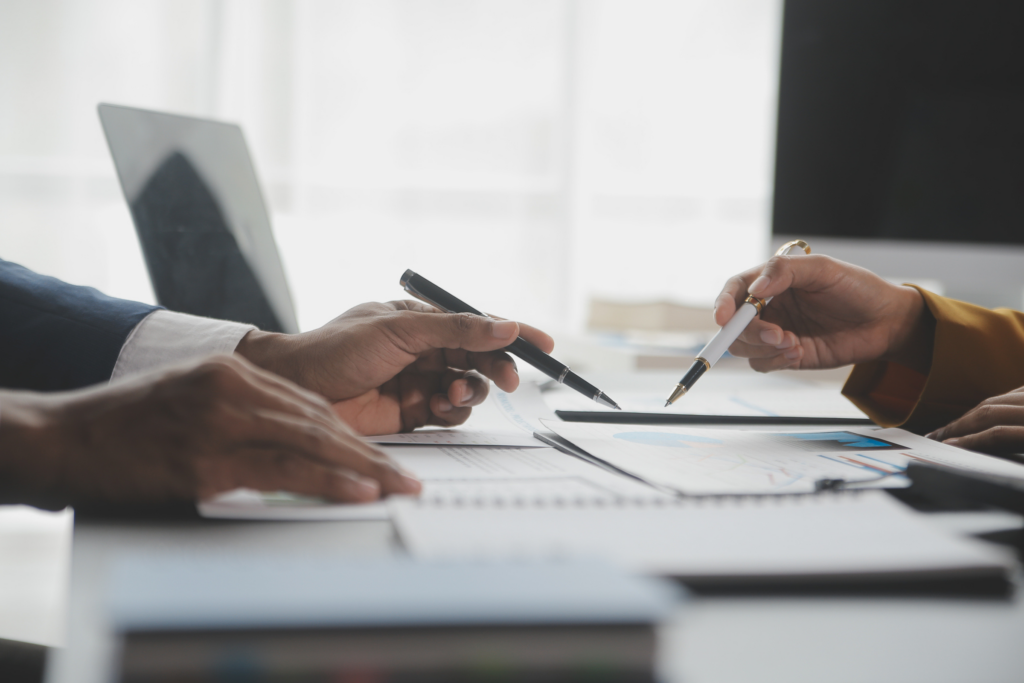 Professionals reviewing financial documents during a business valuation consultation