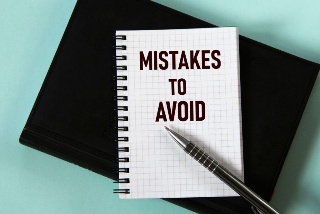 Notebook reading “Mistakes to Avoid,” representing common small business financial mistakes