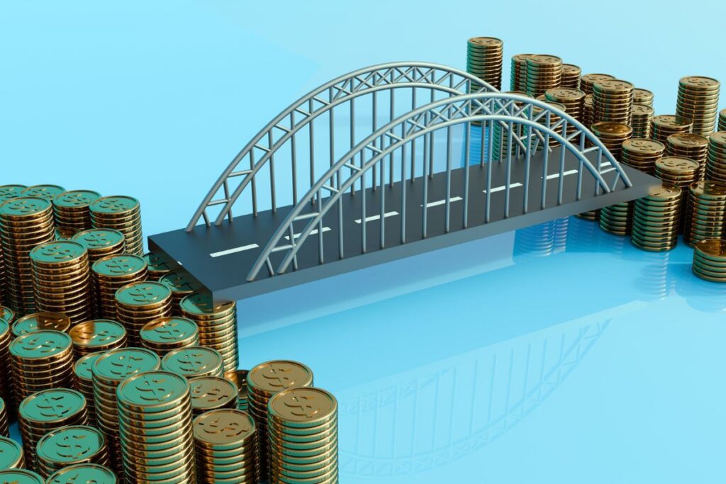 Bridge connecting stacks of coins, representing business value, financing, or financial growth