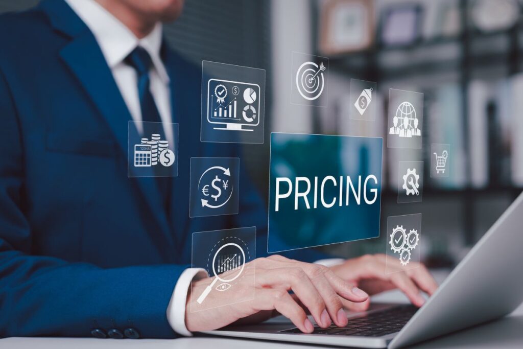Business professional using a laptop with pricing and financial strategy icons