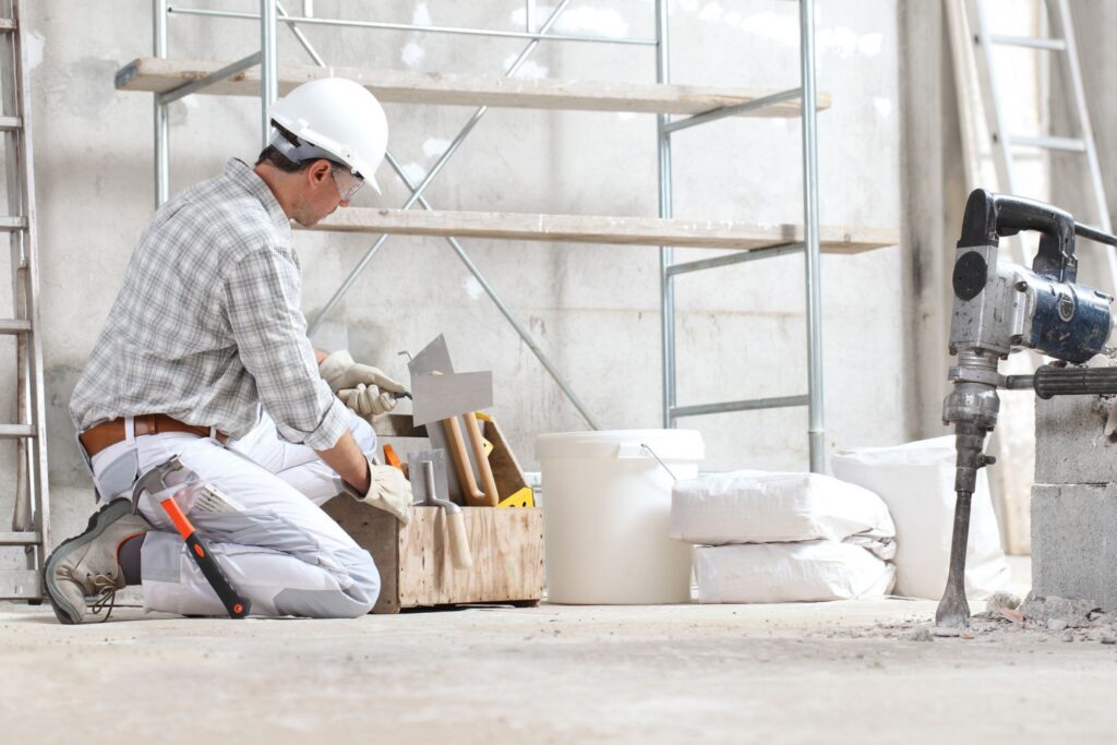 Restoration worker wearing a hard hat working inside a building.